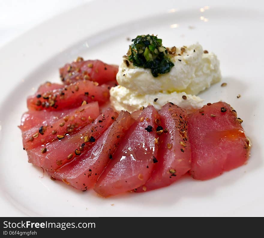 Tuna carpaccio with cheese garlic and basil