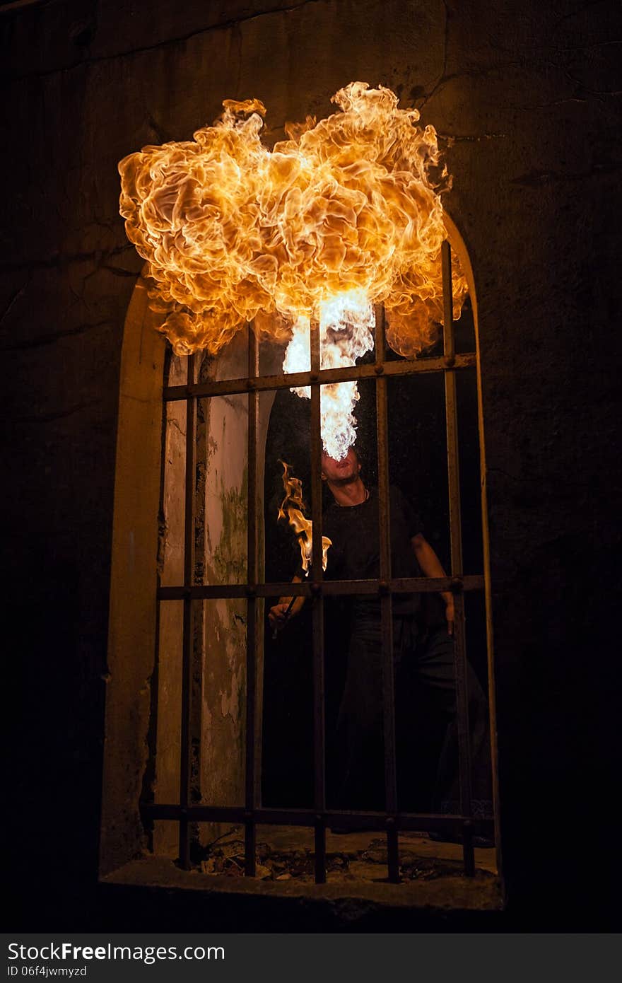 Fire artist blowing fire from his mouth. Fire artist blowing fire from his mouth