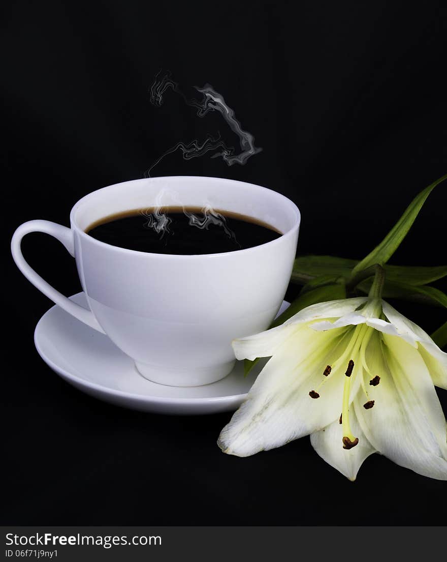 Cup of coffee, steam and white lily on a black background. Cup of coffee, steam and white lily on a black background