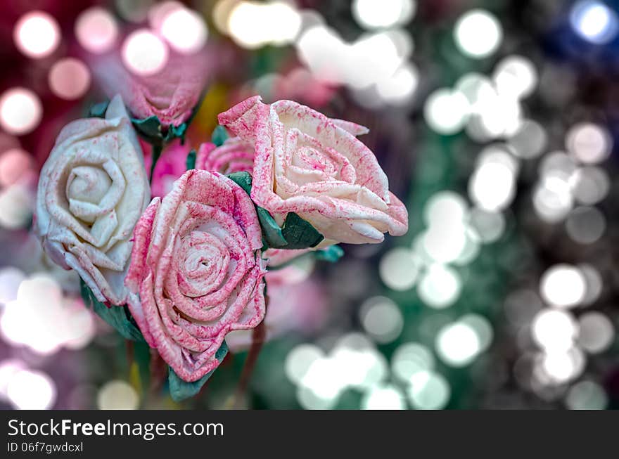 Artificial pink rose flowers on beautiful bokeh lights background