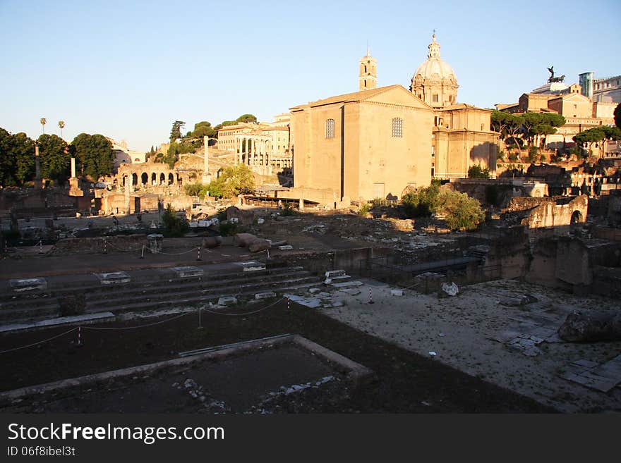 Early morning shot of the Roman Forum walking towards the Vittoriano far in the background