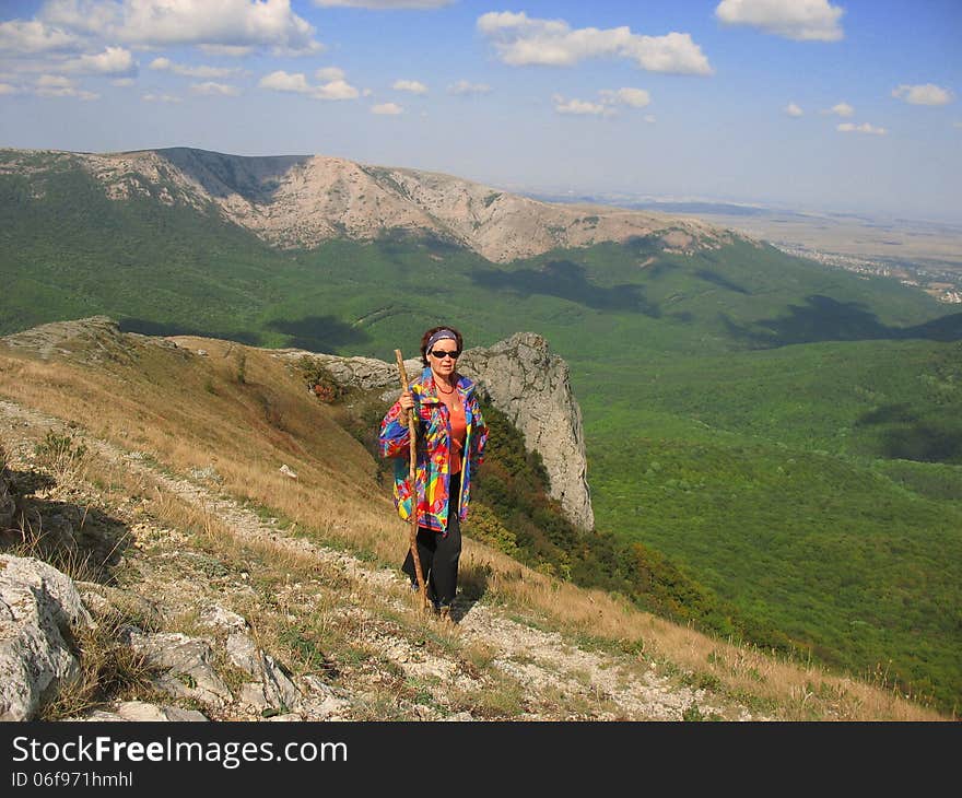 woman travels through the mountains bright day. woman travels through the mountains bright day