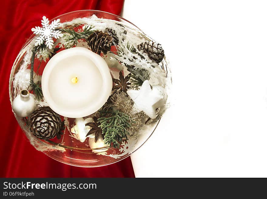 Candle With Winter Decoration On Red Silk And White Background