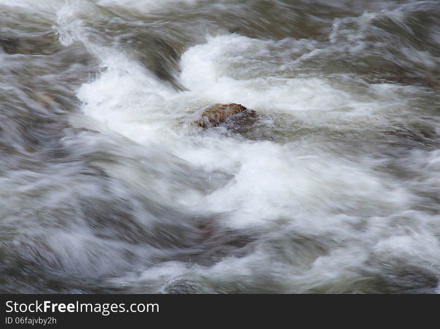 Water streams flowing from the mountains in streams with rocks.