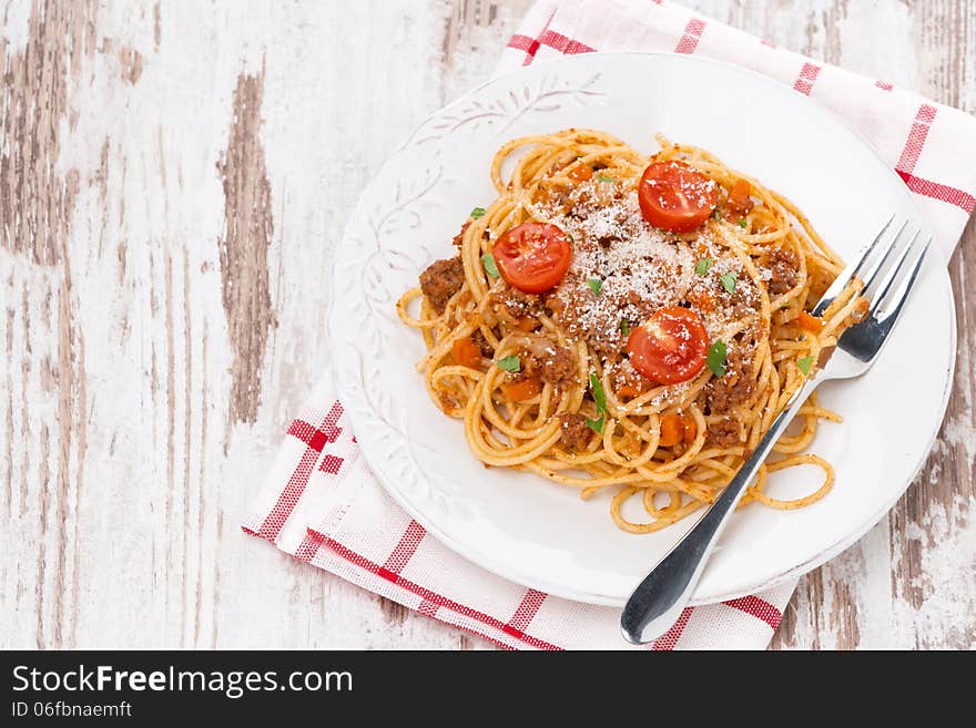 A plate of spaghetti bolognese on wooden table