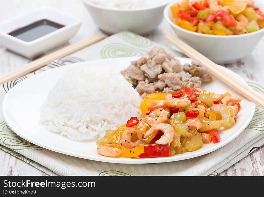 Chinese food - rice, chicken and vegetables with shrimp, close-up