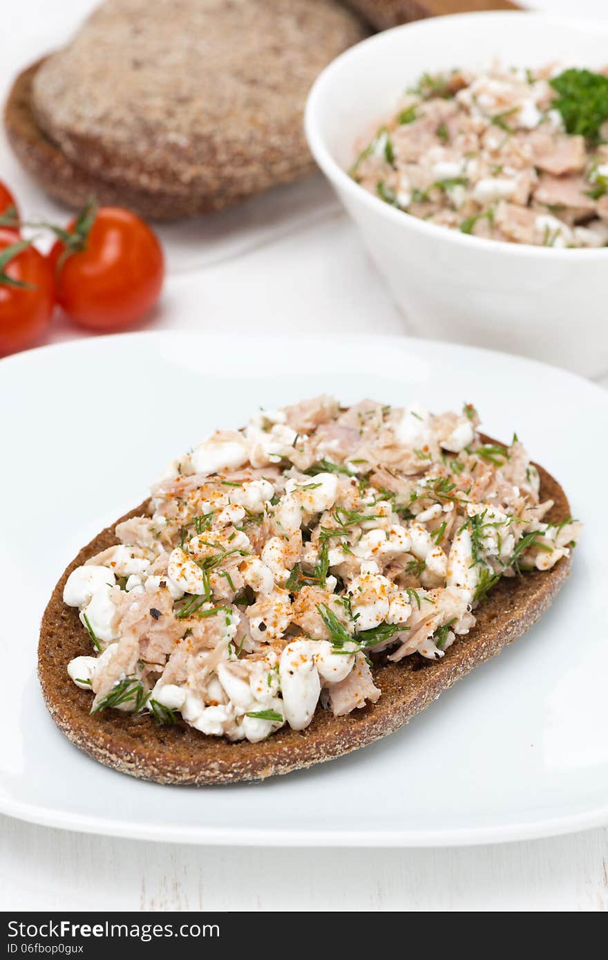 Rye bread with tuna and homemade cheese, vertical, close-up