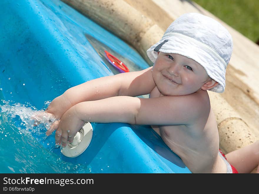 Cute toddler by a swimming pool. Cute toddler by a swimming pool