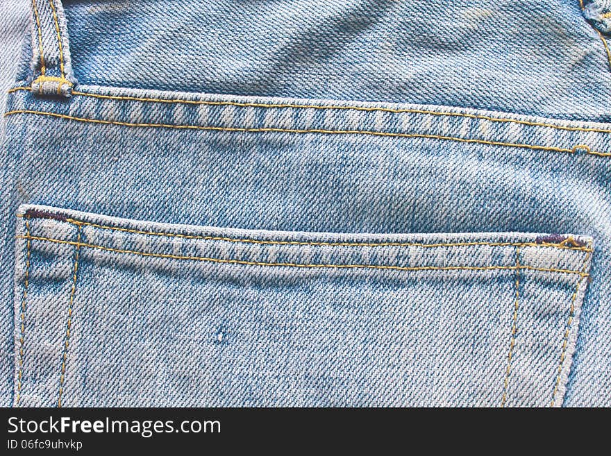 Old blue jeans pocket, close up texture