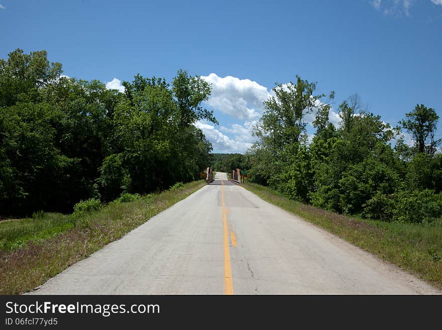 A rural road crossing an old bridge.