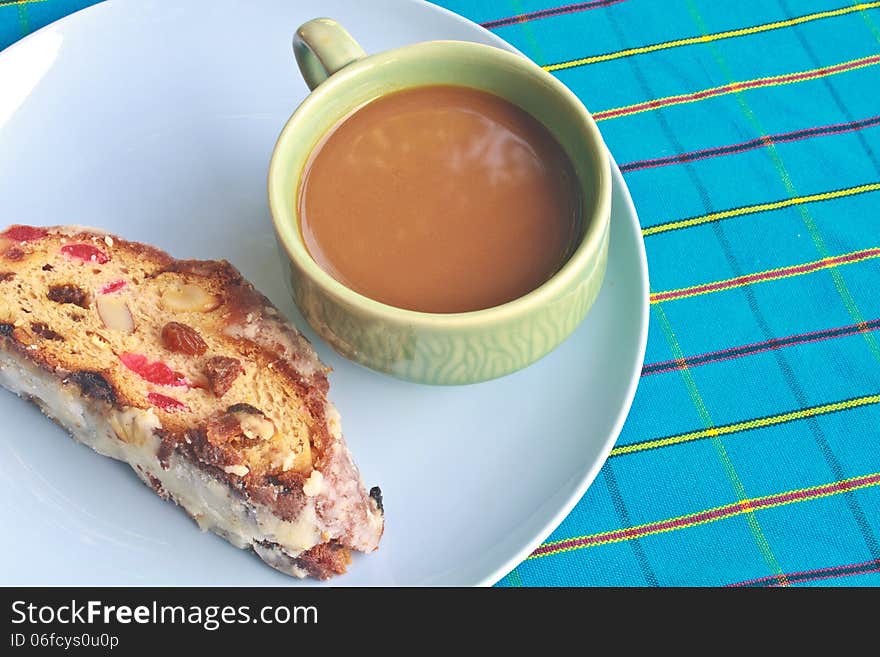 Fruitcake with raisin and Seasoning on table, with hot coffee. Fruitcake with raisin and Seasoning on table, with hot coffee