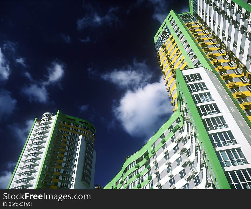 Fragment of modern condominium against a dark blue sky. Fragment of modern condominium against a dark blue sky.