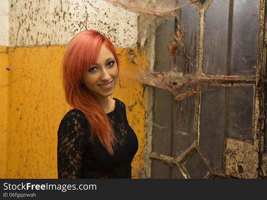 Beautiful young red haired model posing in abandoned buildings. Beautiful young red haired model posing in abandoned buildings