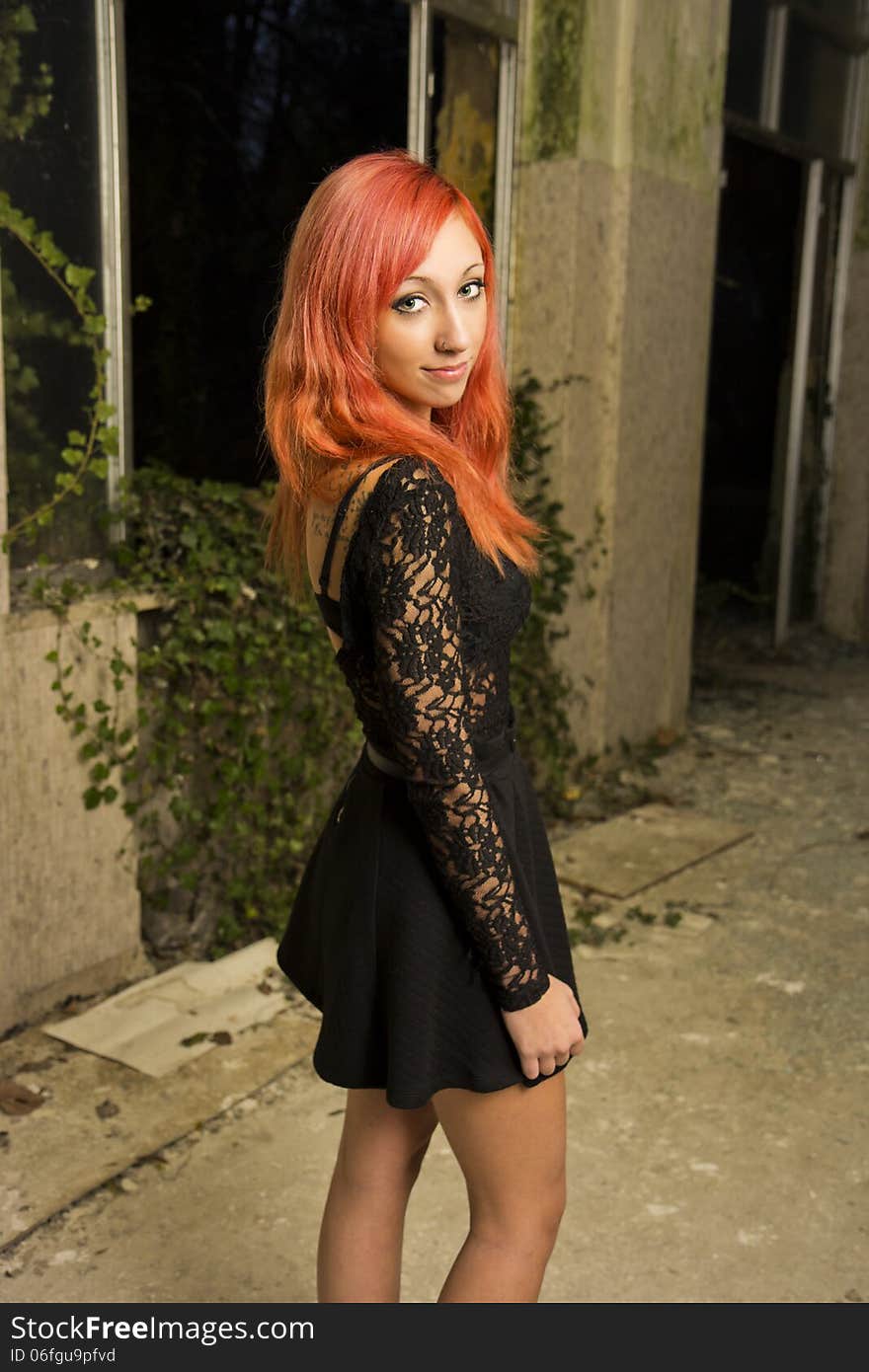 Beautiful young red haired model posing in abandoned buildings. Beautiful young red haired model posing in abandoned buildings