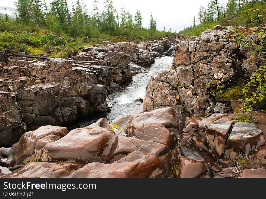 Rocky canyon of the mountain river. Russia, Taimyr Peninsula, Putorana plateau. Rocky canyon of the mountain river. Russia, Taimyr Peninsula, Putorana plateau.