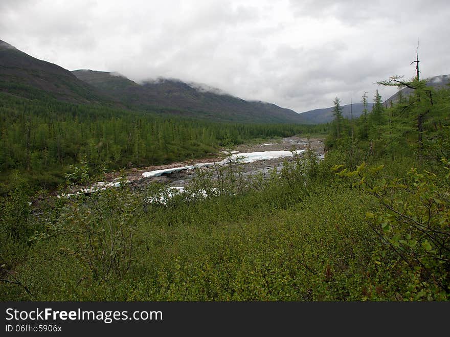 The ice-field in the tideway of the mountain river. The Putorana plateau, Taimyr Peninsula, Russia.