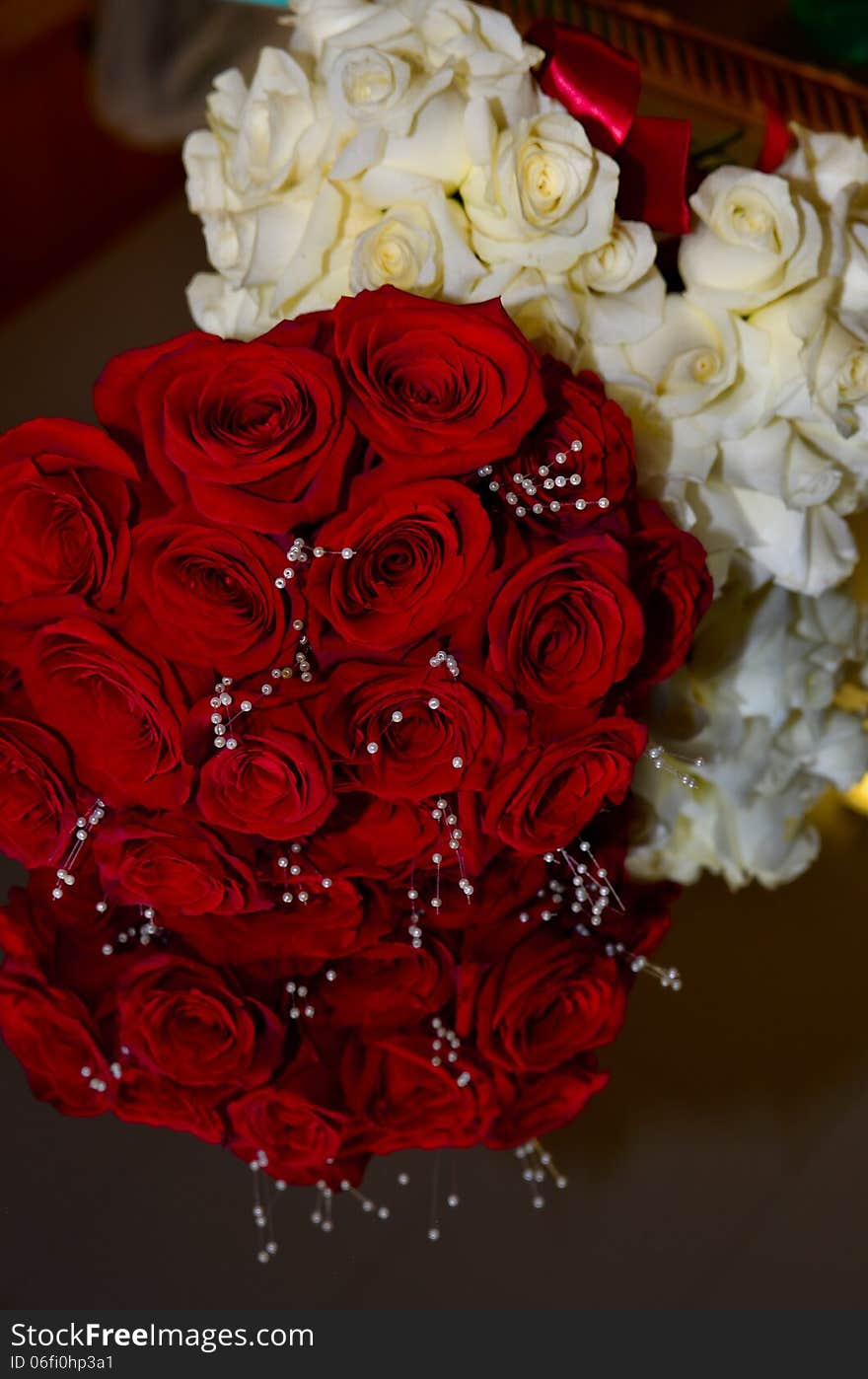 Red and White roses arranged on a mirror at a wedding. Red and White roses arranged on a mirror at a wedding