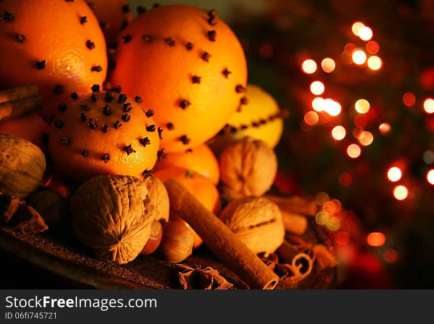 Christmas orange with cloves, fire lights on a background