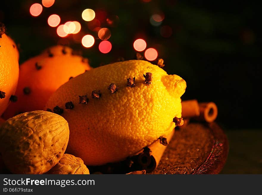 Christmas orange with cloves, fire lights on a background. Christmas orange with cloves, fire lights on a background