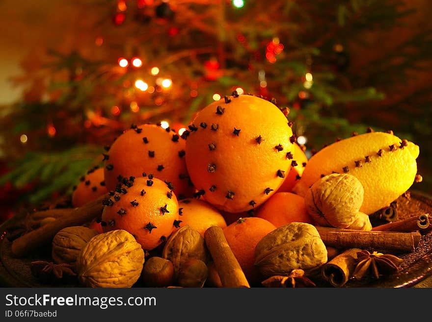 Christmas orange with cloves, fire lights on a background