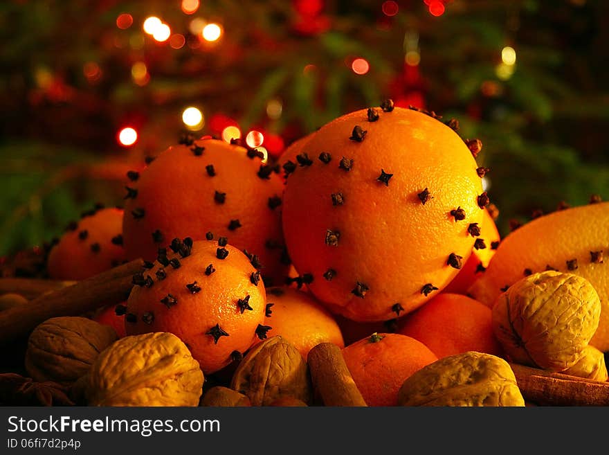 Christmas orange with cloves, fire lights on a background