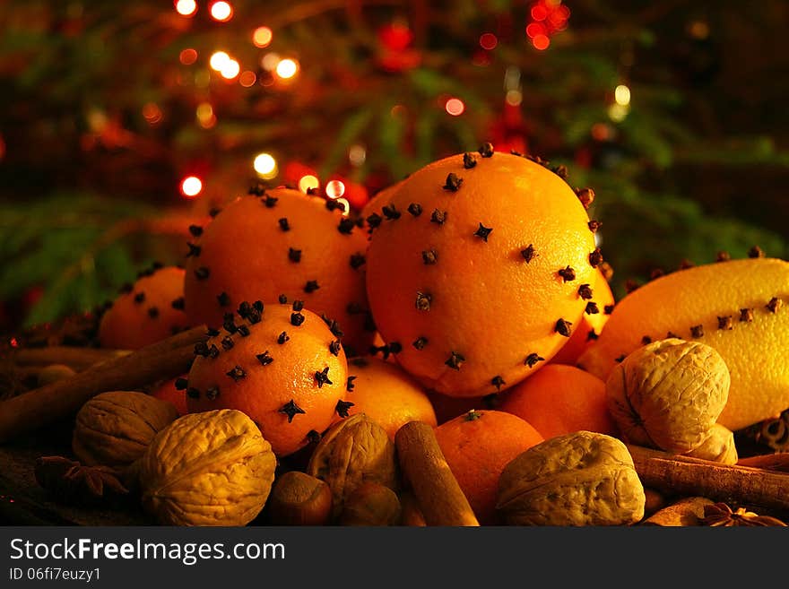 Christmas orange with cloves, fire lights on a background