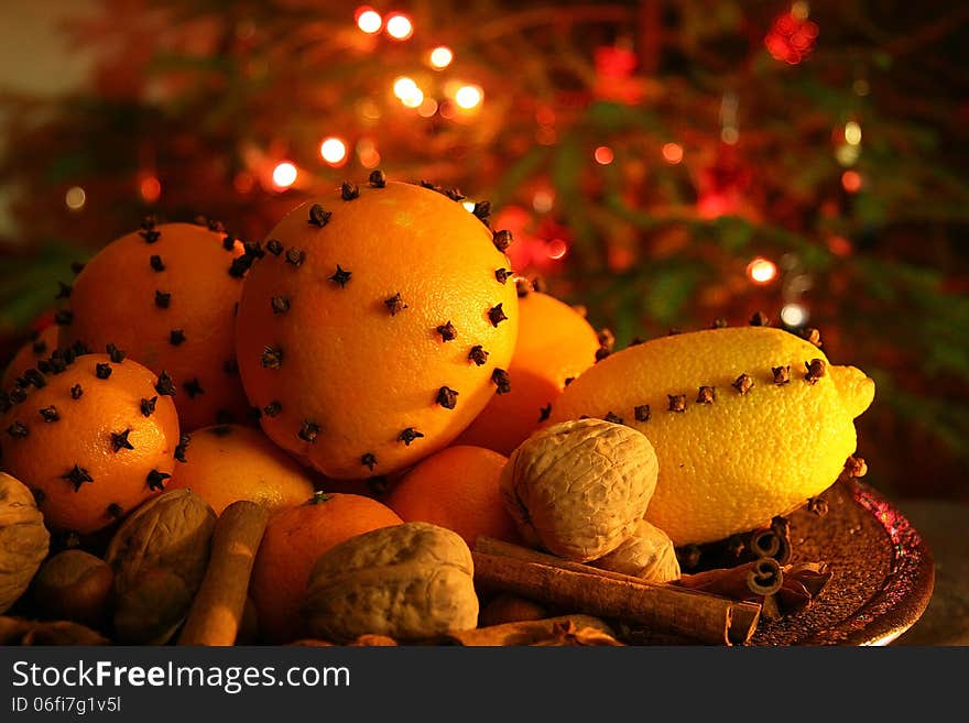 Christmas orange with cloves, fire lights on a background