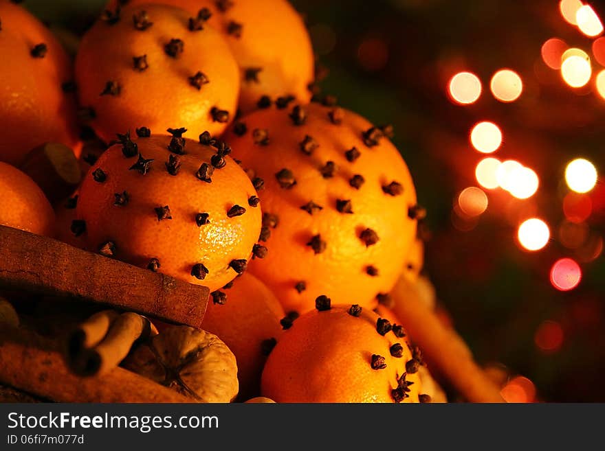 Christmas orange with cloves, fire lights on a background