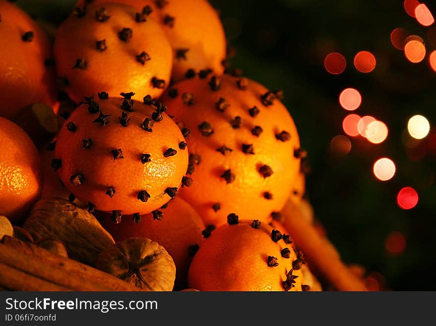 Christmas orange with cloves, fire lights on a background