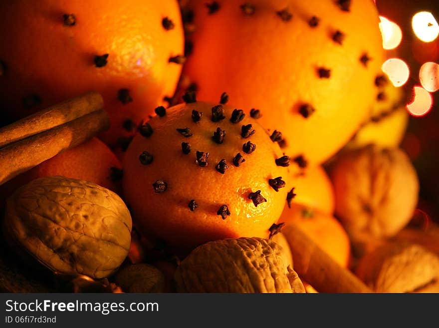 Christmas orange with cloves, fire lights on a background