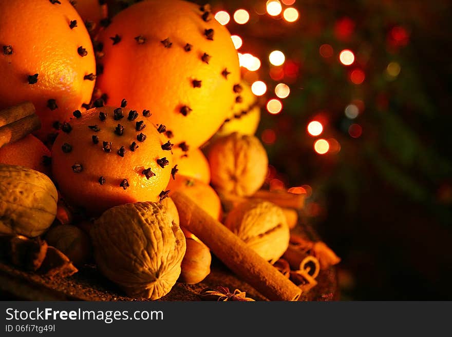 Christmas orange with cloves, fire lights on a background