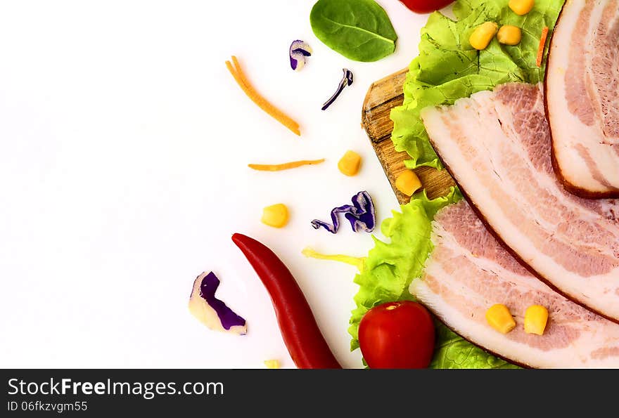 Ham with vegetables on a white background