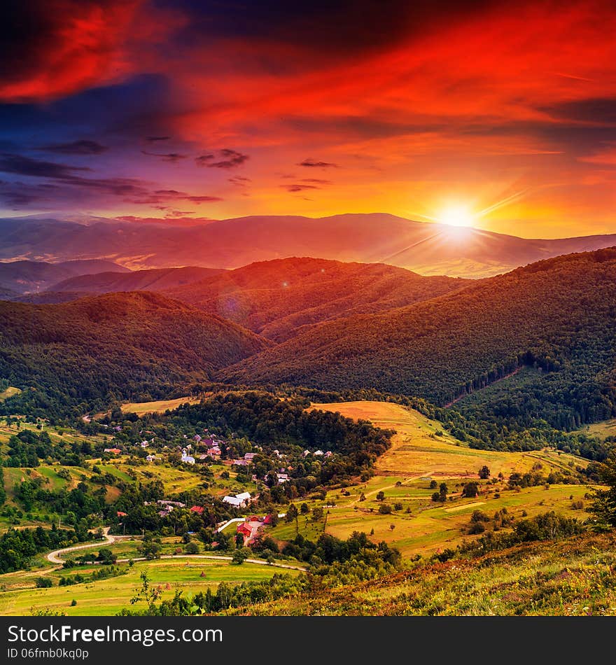 Light falls on hillside with autumn forest in mountain