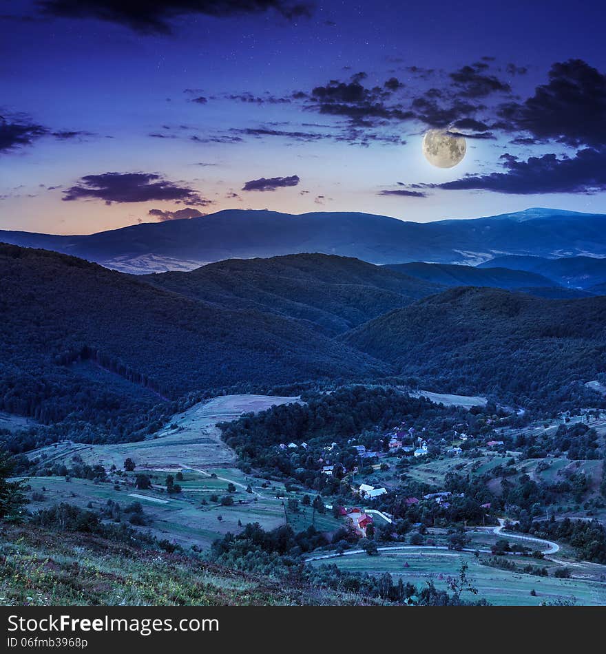 Moon light falls on hillside with autumn forest in mountain