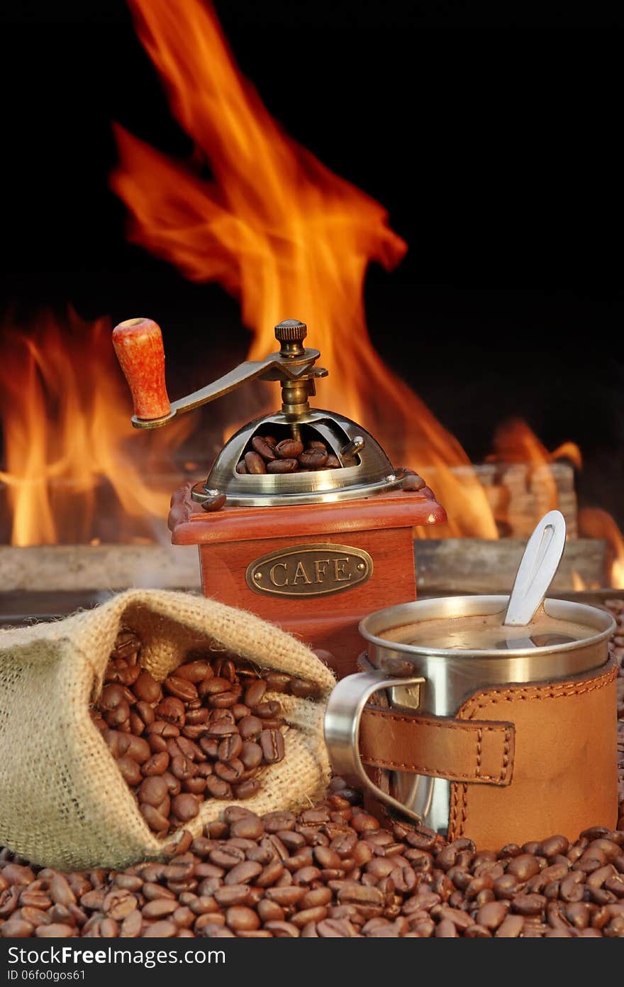 Stainless Steel Coffee Mug And Old Grinder With Beans