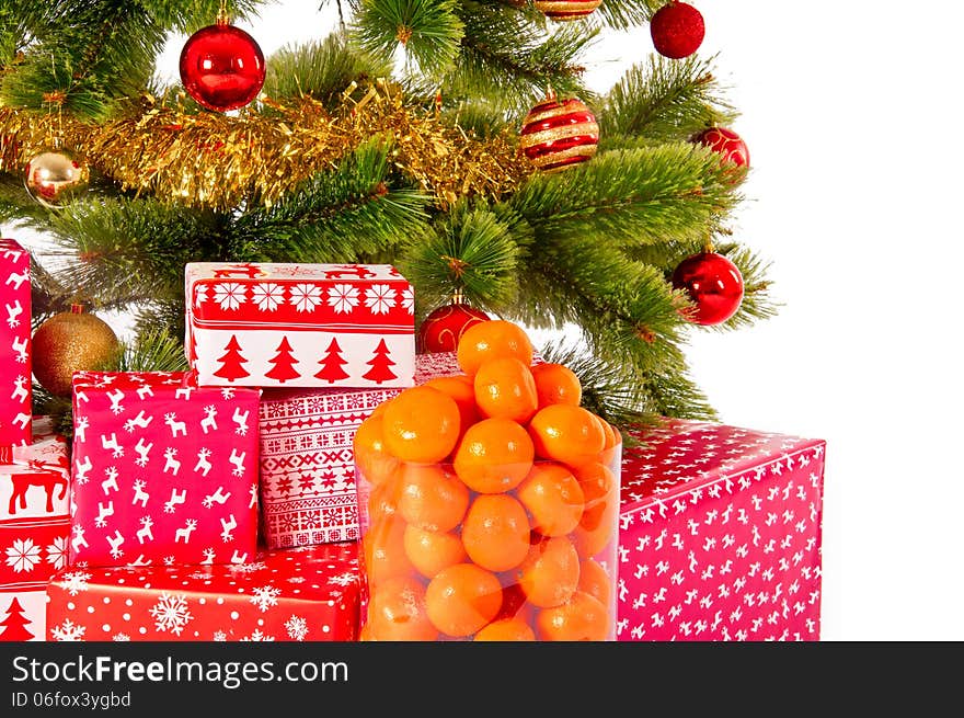 Christmas tree with gifts and mandarines