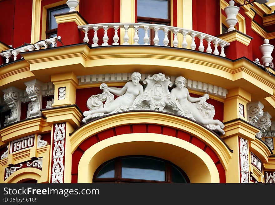 Red-yellow vintage buildings wall with sculpture. Red-yellow vintage buildings wall with sculpture