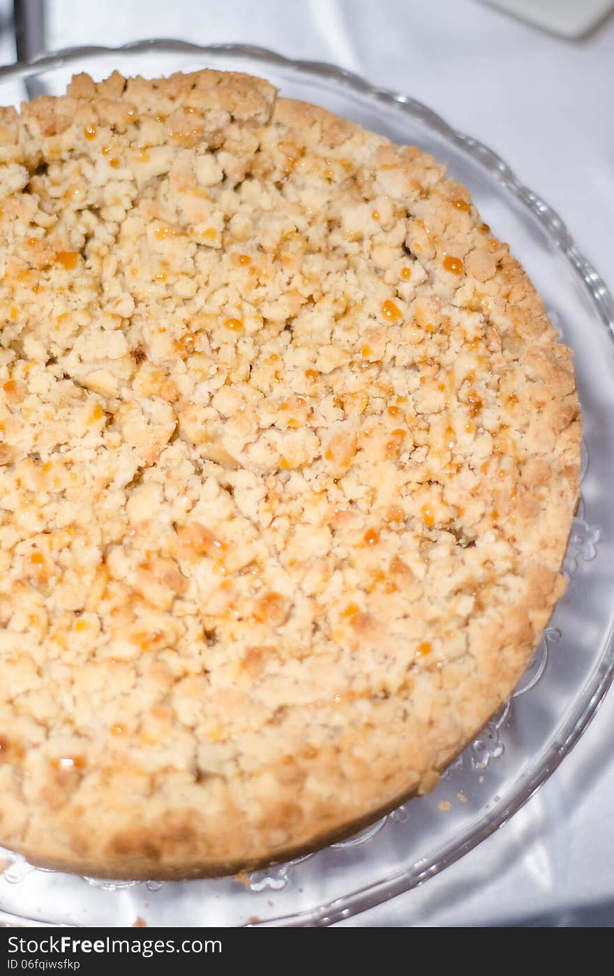 Apple crumble tart detail on the table. Apple crumble tart detail on the table