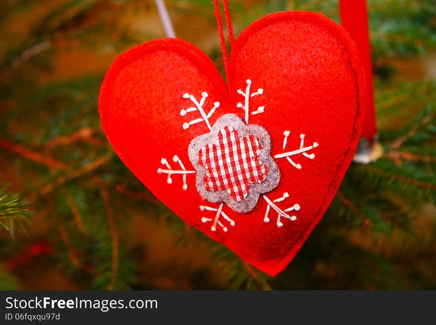 Red Christmas heart decoration on a tree. Red Christmas heart decoration on a tree