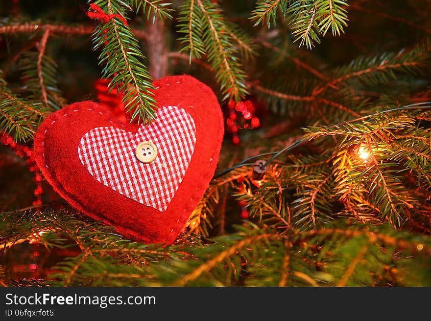 Red Christmas heart decoration on a tree. Red Christmas heart decoration on a tree