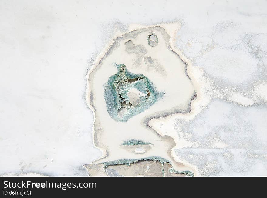 Closeup of a damaged fiberglass boat hull showing hole and cracks. Closeup of a damaged fiberglass boat hull showing hole and cracks.