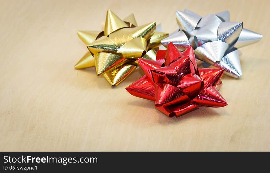 Colorful bow with red, gold and silver.