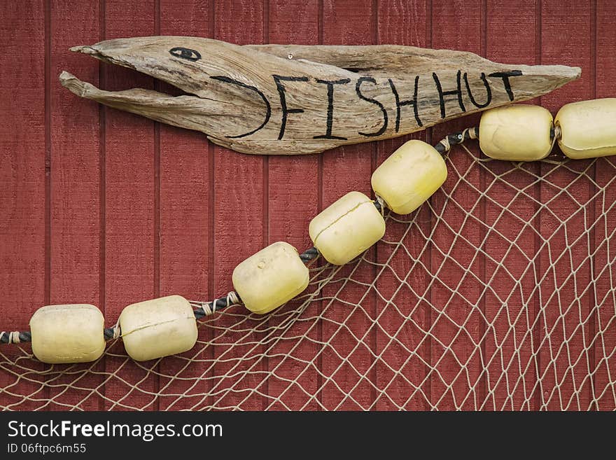 Sign on house of fisherman with net