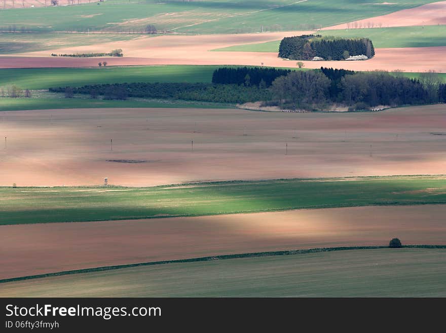 Agricultural landscape with colorful fields and forests