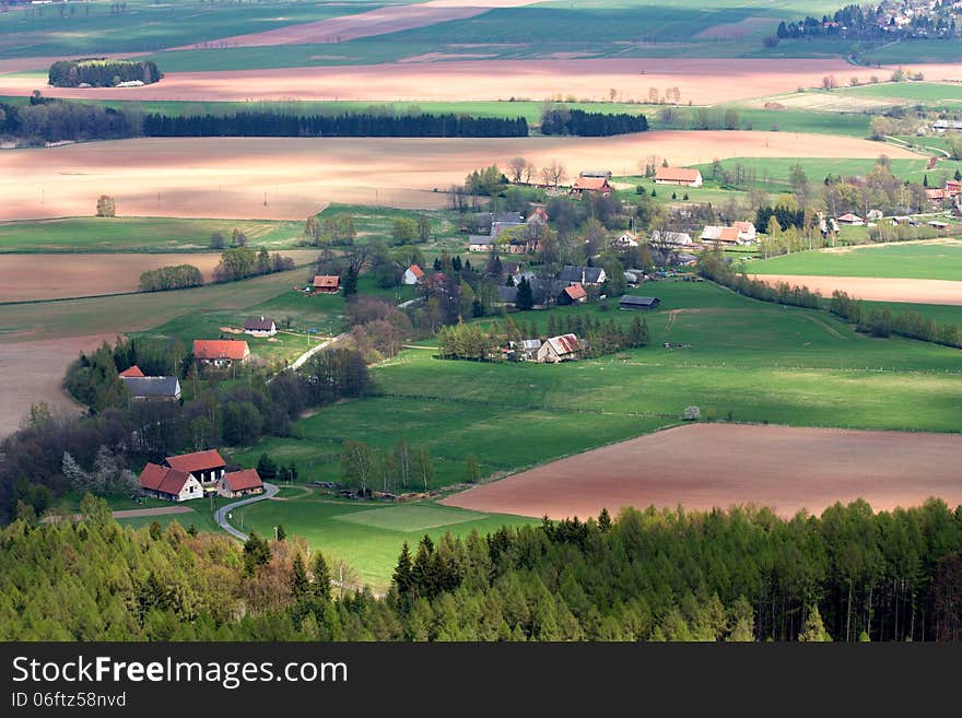 Village in the countryside with fields and forests around