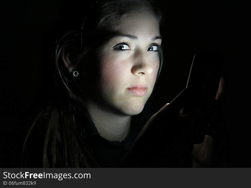 Teen Girls Face Lit by Cell Phone