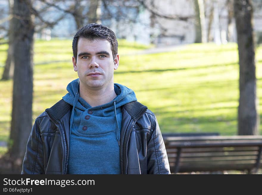 Portrait of serious man looking at the camera, outdoor.