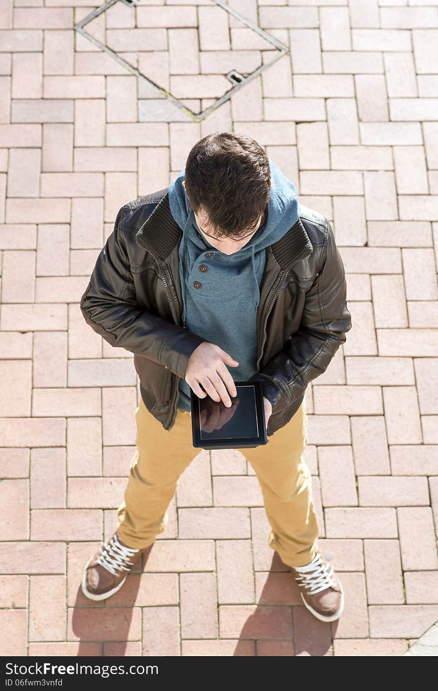 Man With Tablet Computer In The Street.