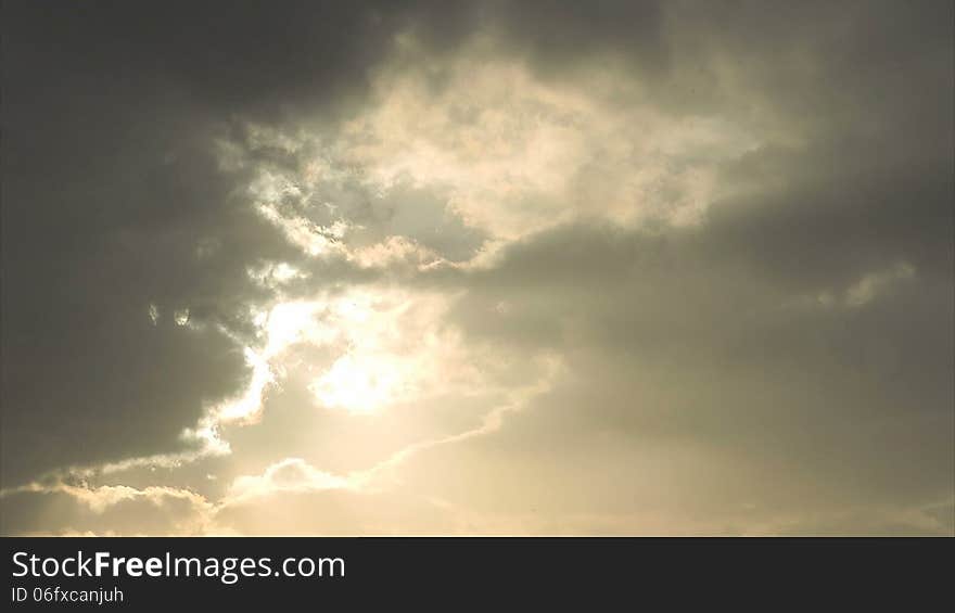 Dramatic clouds obscure the sun. Timelapse