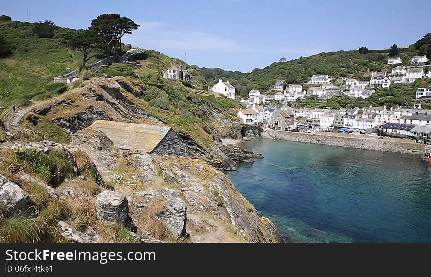 Harbour view in summer Polperro Cornwall England UK during heatwave with blue sky and sea, beautiful Cornish fishing port. Harbour view in summer Polperro Cornwall England UK during heatwave with blue sky and sea, beautiful Cornish fishing port